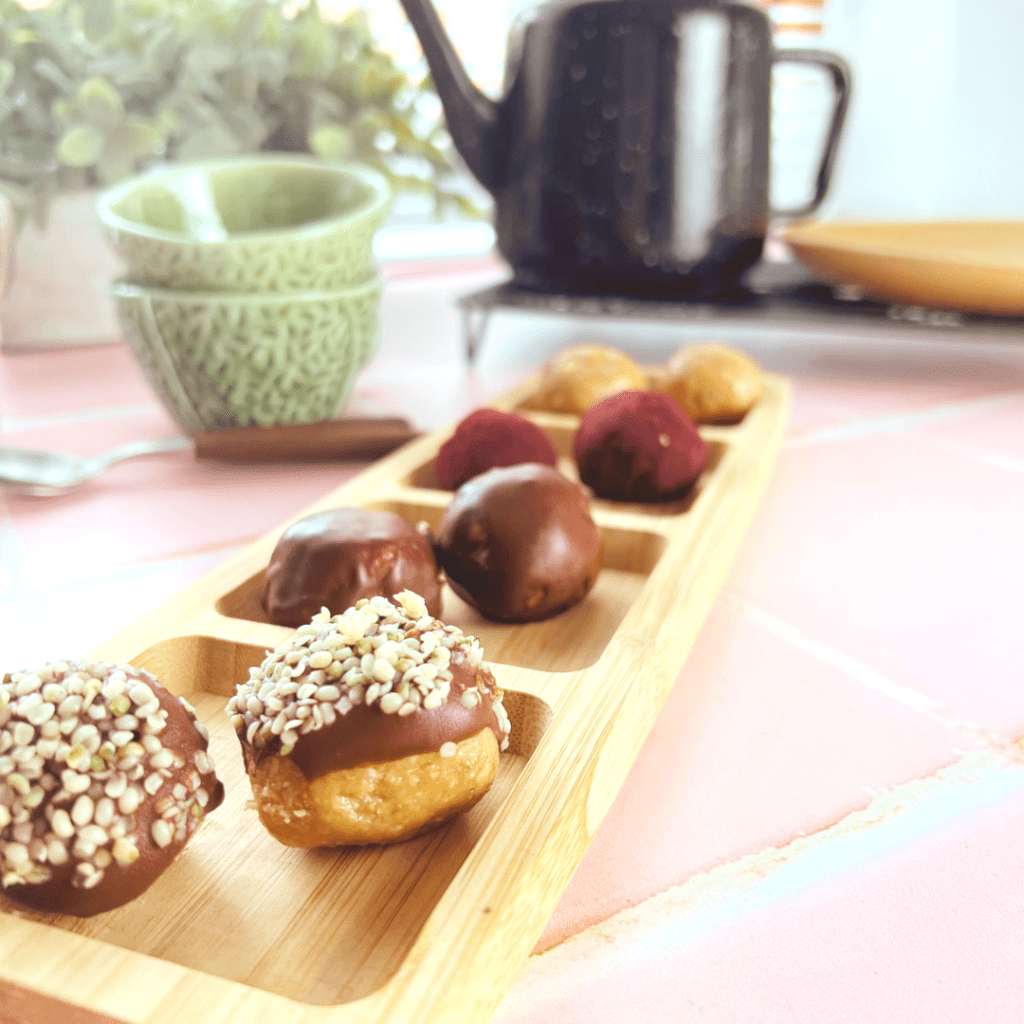 Energy balls coated in chocolate and superfood powders