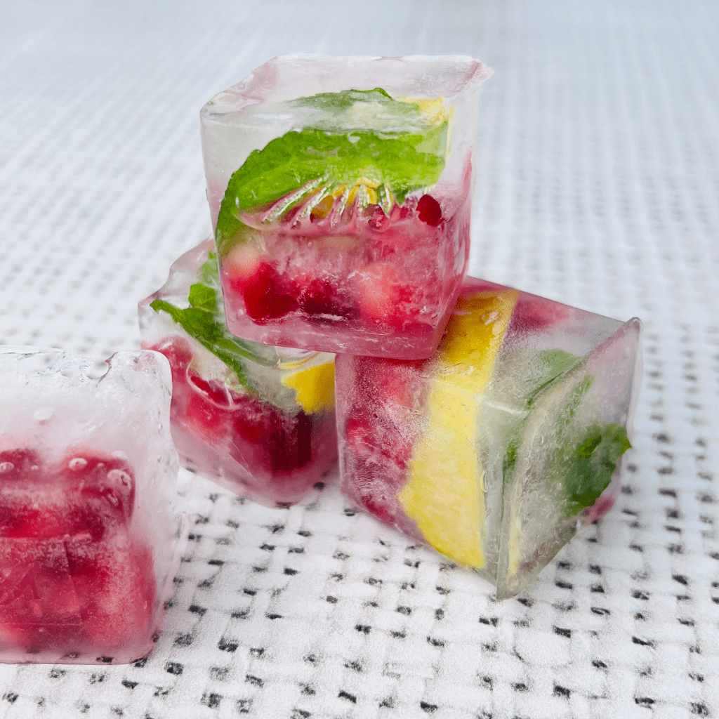 Ice blocks with mint, lemon and pomegranate in them